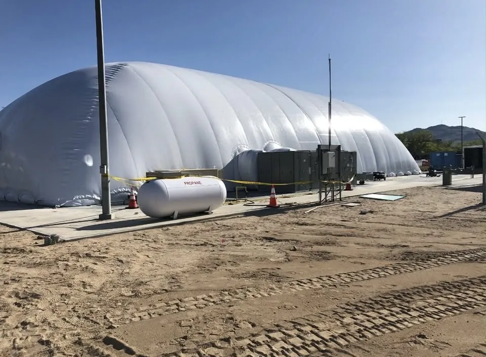 The air dome installed on site with propane tank, rooftop HVAC unit and electrical service alongside